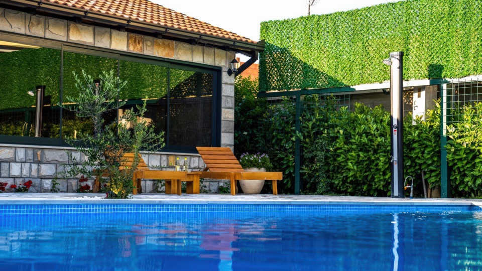 Villa Lapis poolside with sunbeds and Herzegovina views